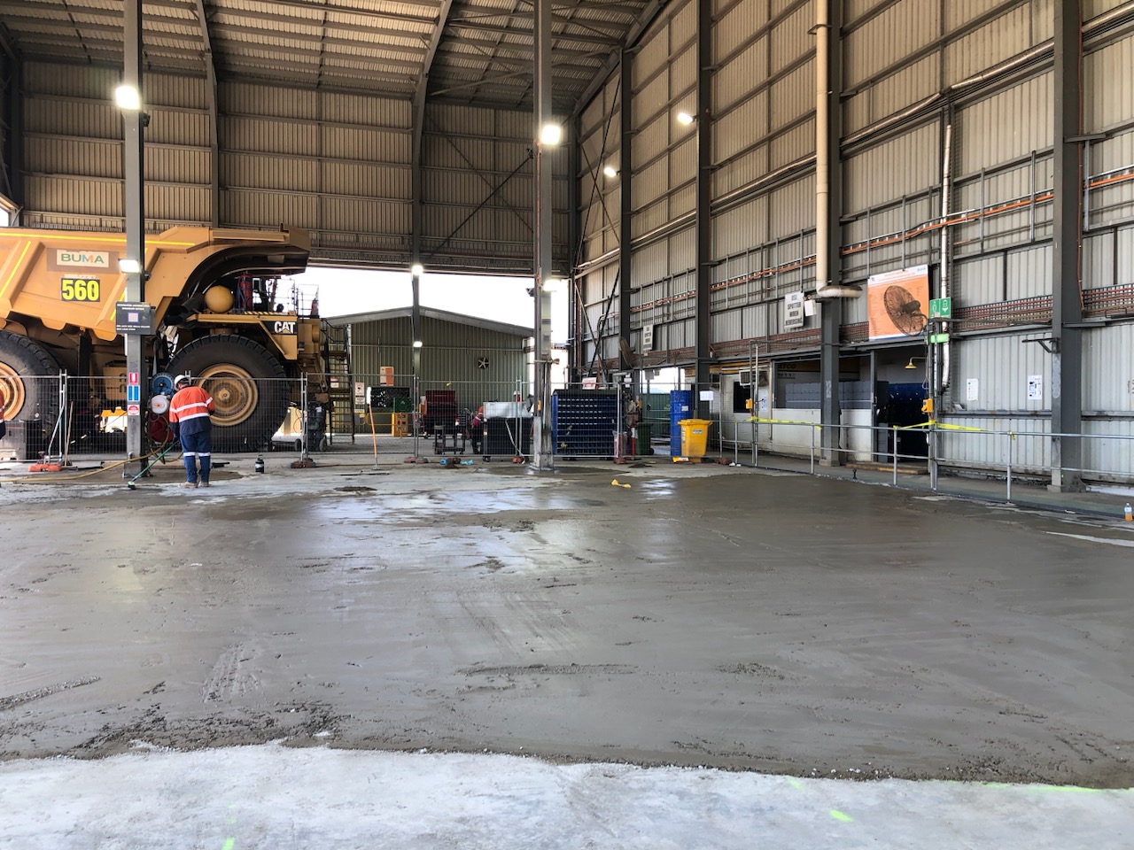 CAT 560 mining truck and crew preparing the workshop floor for Rombus install